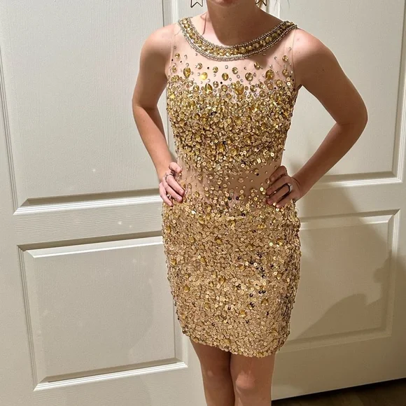 JOVANI mini illusion dress. With sheer material and gold stones. Size 2